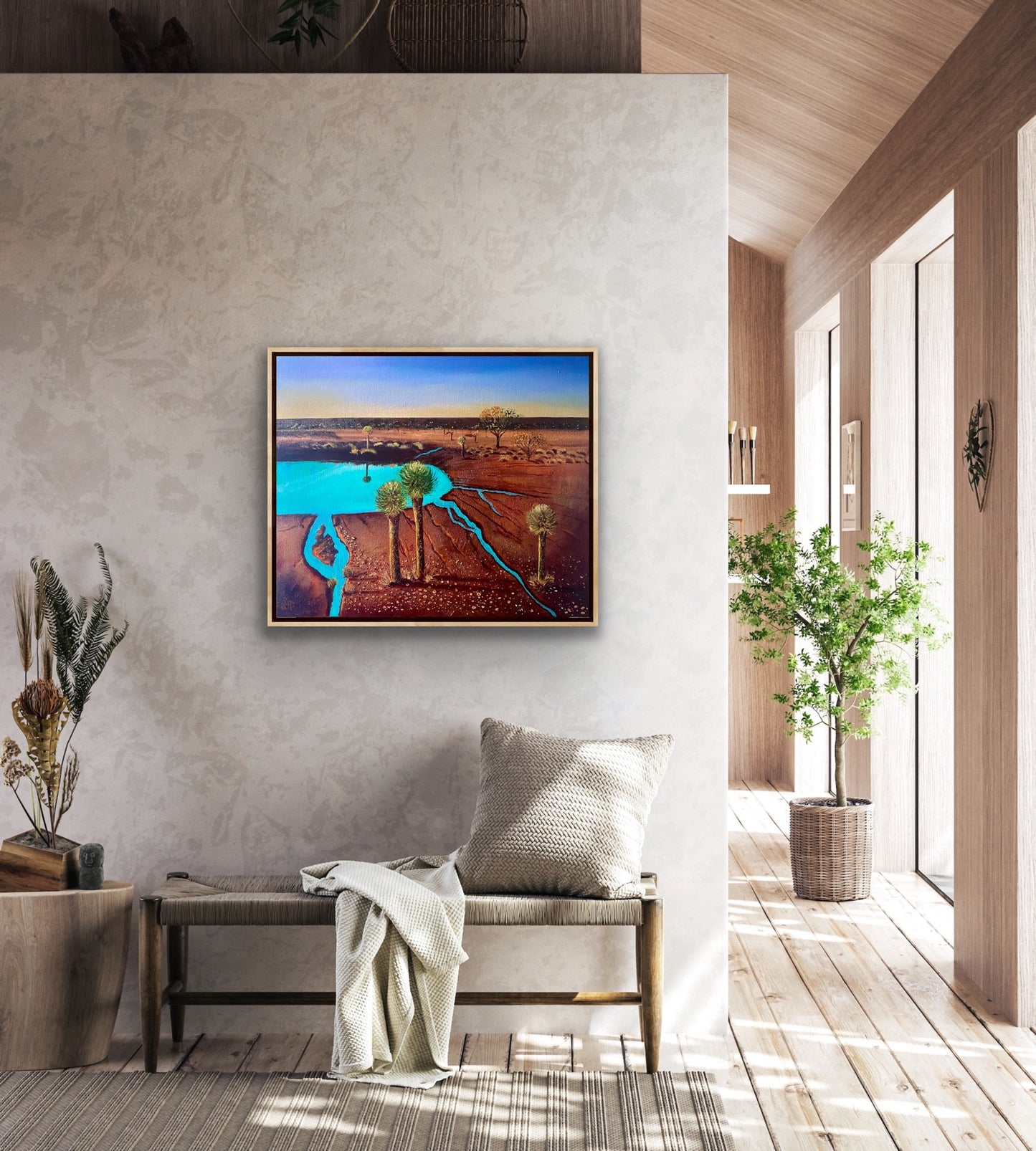 A mixed media textured painting of the dramatic red desert with a turquoise billabong and grass tress and blue sky by Wendy Peters