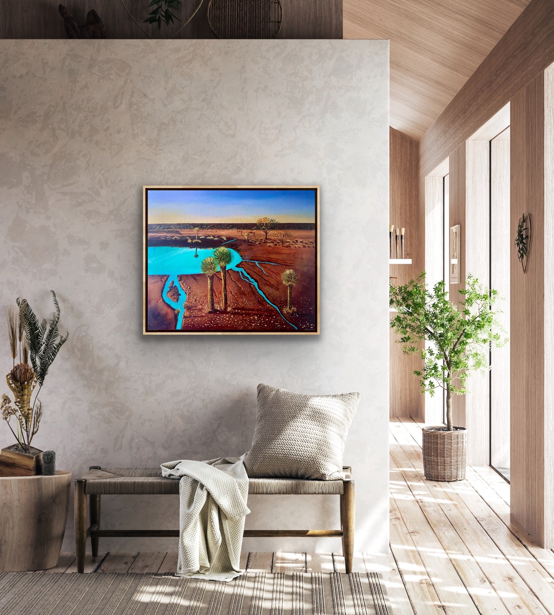 A mixed media textured painting of the dramatic red desert with a turquoise billabong and grass tress and blue sky by Wendy Peters